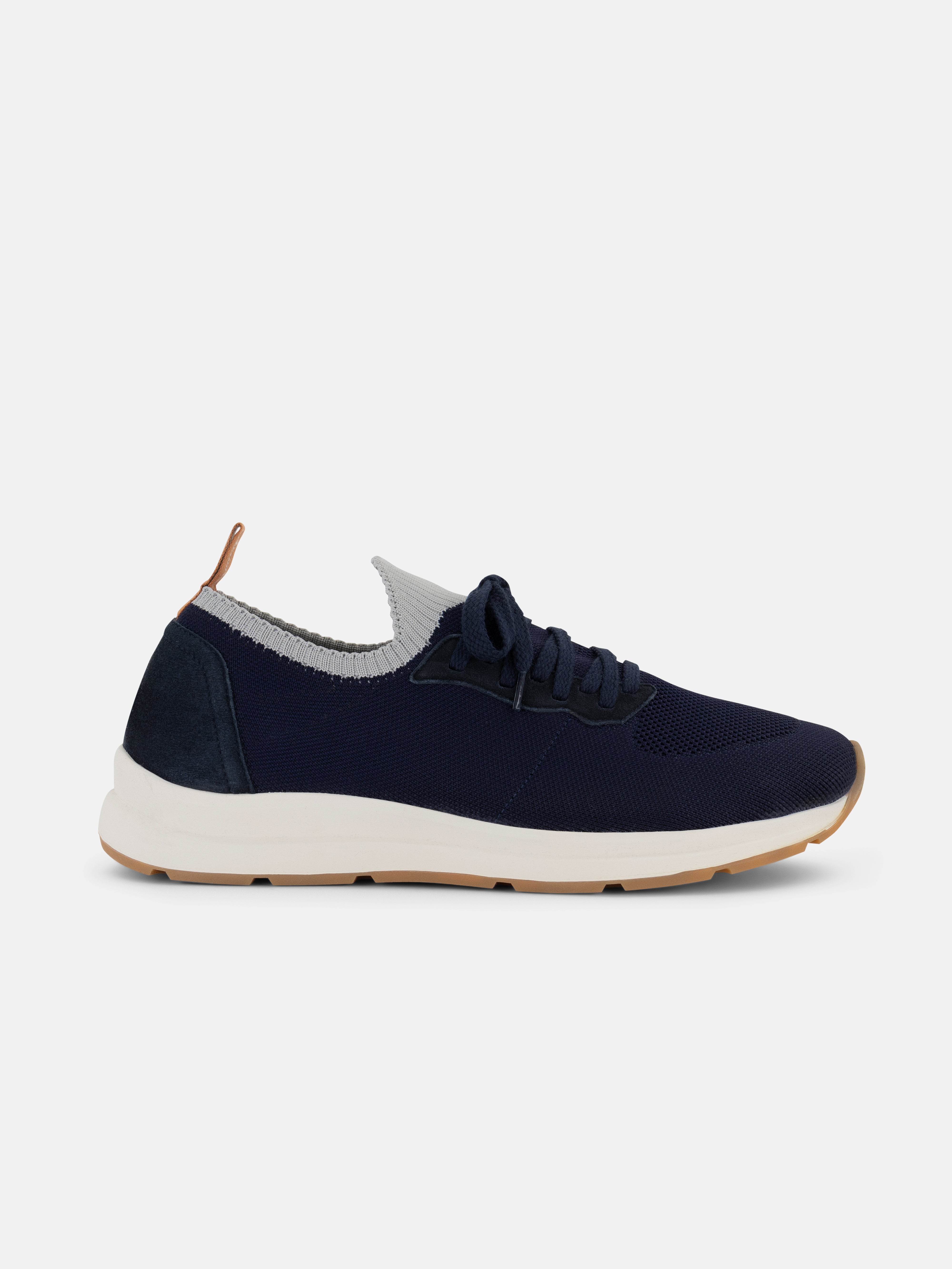 Navy blue sneaker with white sole on a light gray background